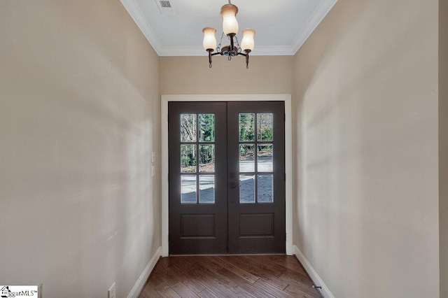 entryway with hardwood / wood-style flooring, french doors, crown molding, and a notable chandelier