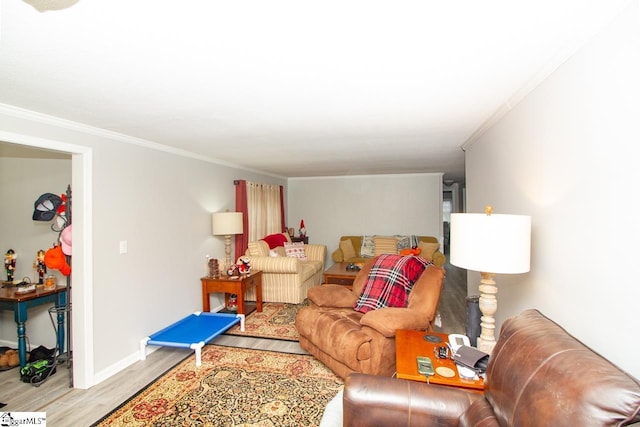 living room with light hardwood / wood-style floors and crown molding