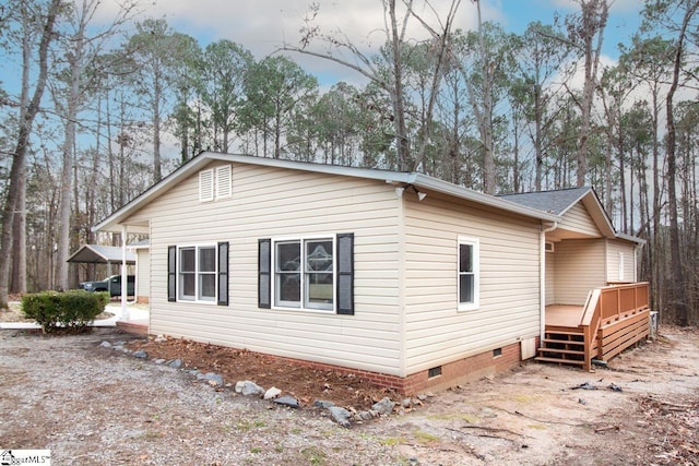 view of side of home with a deck