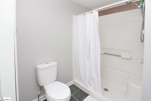 bathroom with a shower with curtain, toilet, and tile patterned floors