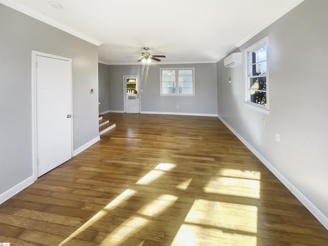 unfurnished room featuring a wall mounted AC, plenty of natural light, and dark hardwood / wood-style floors