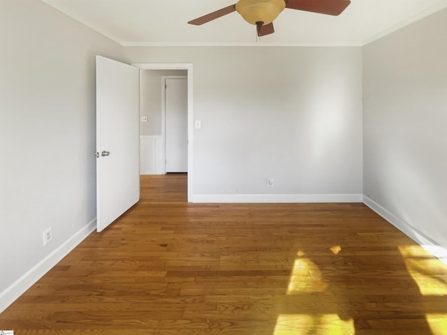 unfurnished room featuring dark hardwood / wood-style floors, ceiling fan, and ornamental molding