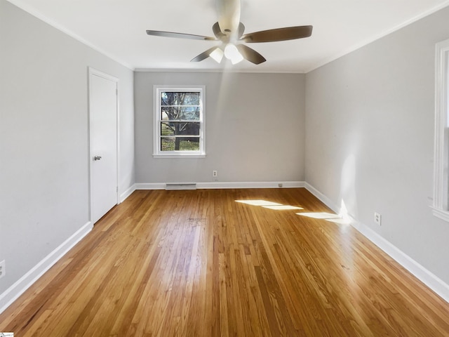 spare room featuring ceiling fan, light hardwood / wood-style floors, and crown molding