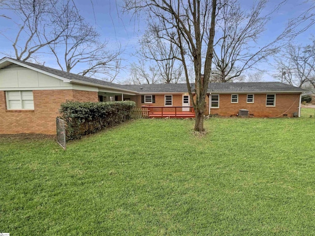 view of yard featuring central AC unit and a wooden deck