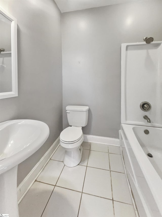 bathroom featuring tile patterned floors, toilet, and shower / washtub combination