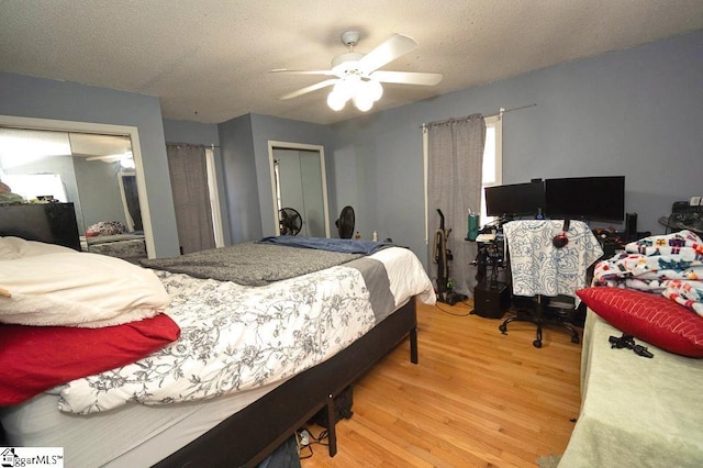 bedroom with ceiling fan, hardwood / wood-style floors, and a textured ceiling