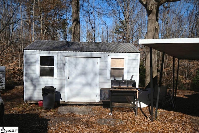 view of outbuilding with a carport