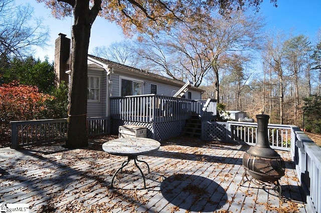 wooden terrace featuring a fire pit