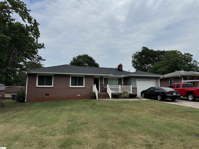 ranch-style home with covered porch, a garage, and a front lawn