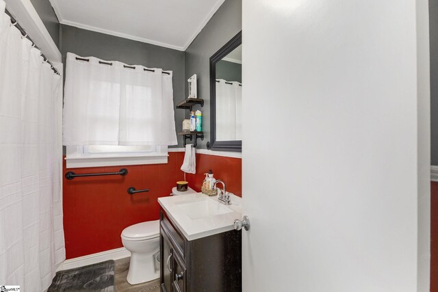 bathroom featuring hardwood / wood-style flooring, vanity, ornamental molding, and toilet