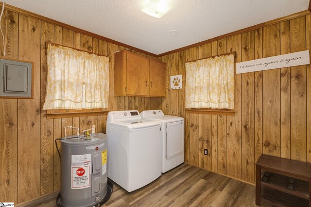 clothes washing area featuring cabinets, separate washer and dryer, water heater, dark hardwood / wood-style flooring, and electric panel