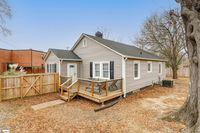 rear view of house with central AC unit and a wooden deck