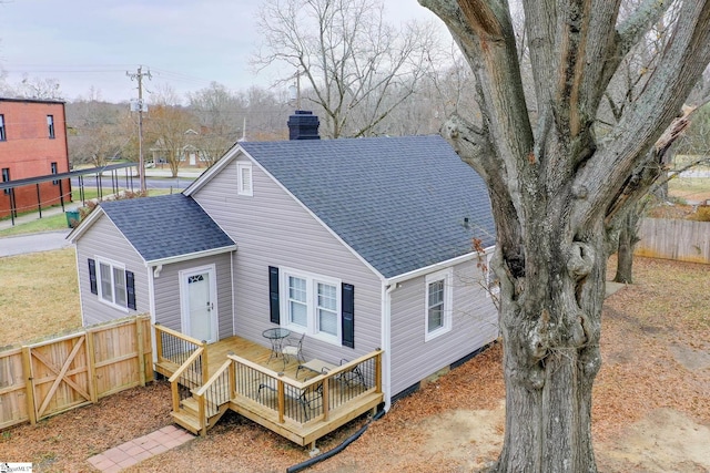 back of house featuring a wooden deck