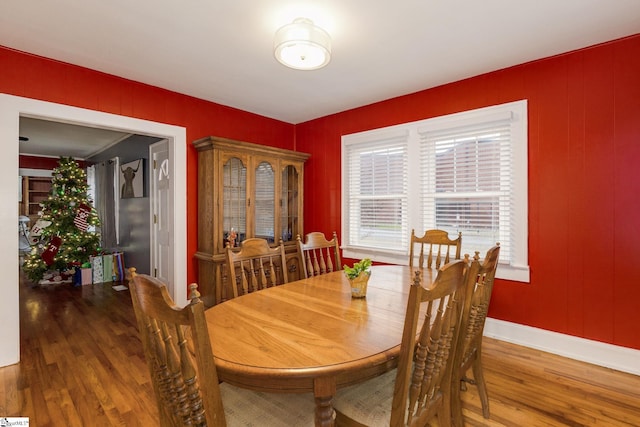 dining space with hardwood / wood-style floors