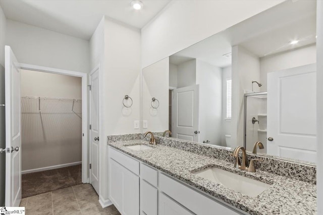 bathroom with vanity, toilet, and a shower with shower door