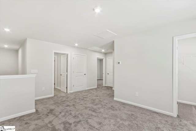 unfurnished room featuring light colored carpet