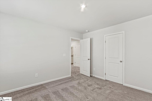 unfurnished bedroom featuring light colored carpet