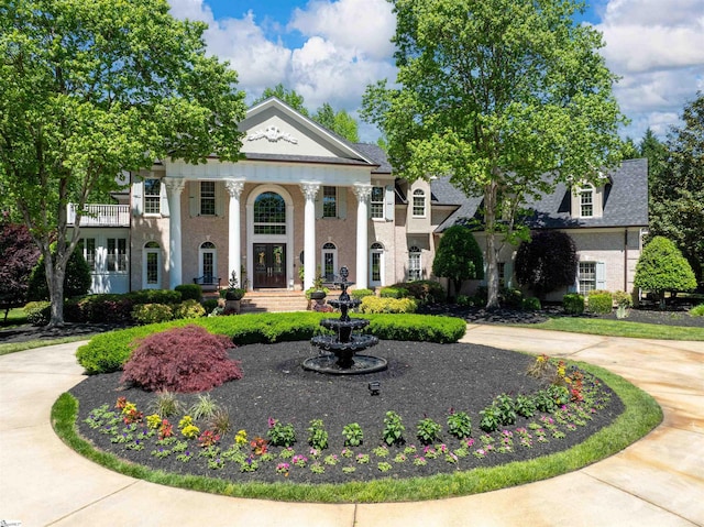 greek revival inspired property with a balcony