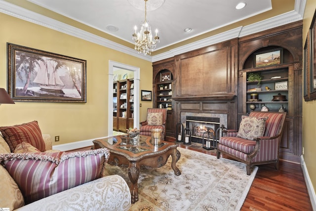 living room featuring dark hardwood / wood-style floors, crown molding, and a notable chandelier