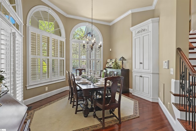 dining space featuring crown molding, dark wood-type flooring, and an inviting chandelier