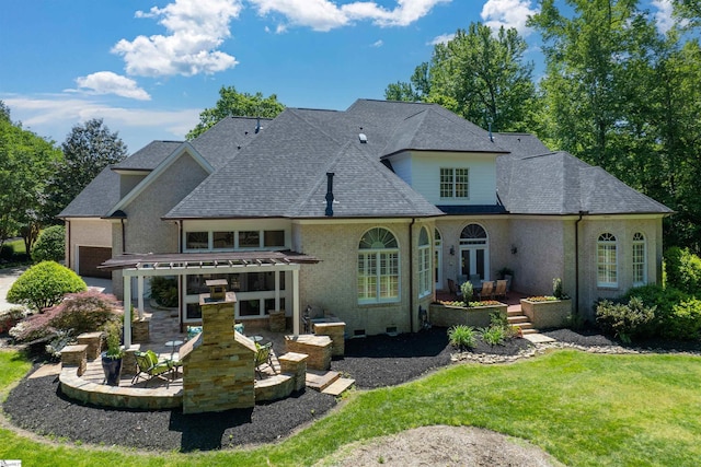 rear view of property featuring french doors, a patio area, and a lawn