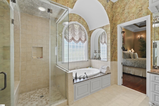 bathroom with plus walk in shower, vanity, crown molding, and tile patterned flooring