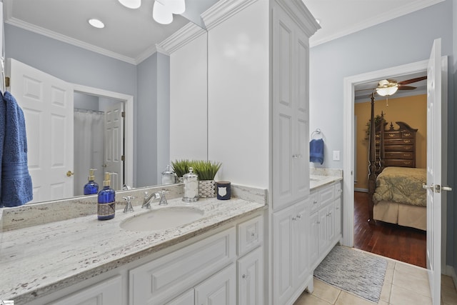 bathroom featuring tile patterned flooring, vanity, ceiling fan, and crown molding