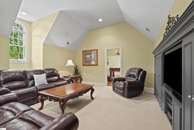 carpeted living room featuring ceiling fan and lofted ceiling