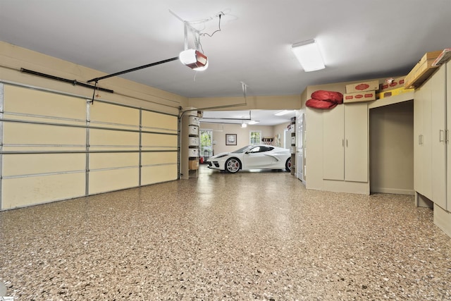 garage with a garage door opener and ceiling fan