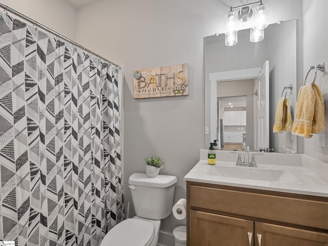 bathroom featuring vanity, a shower with shower curtain, and toilet