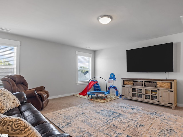 living room featuring carpet and plenty of natural light