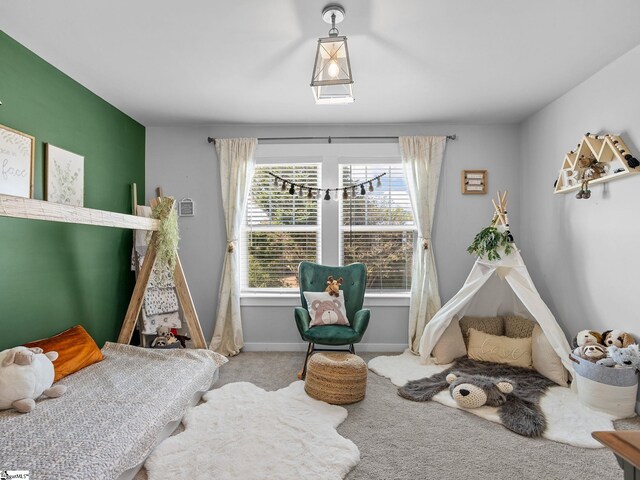 carpeted bedroom featuring multiple windows