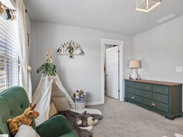 living area featuring light colored carpet and a healthy amount of sunlight