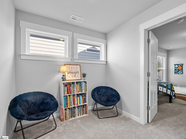 sitting room with light colored carpet