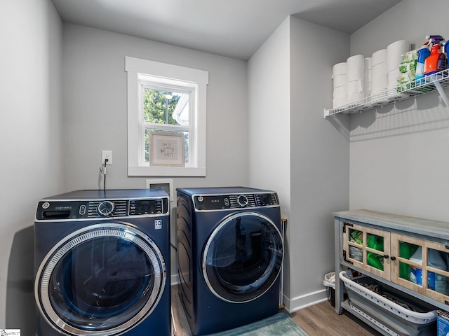 washroom featuring washer and clothes dryer and dark hardwood / wood-style flooring