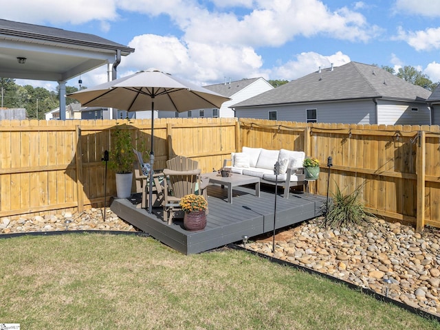 wooden deck featuring an outdoor living space and a yard