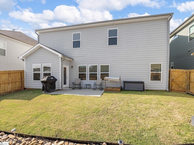 rear view of house with a patio area and a yard