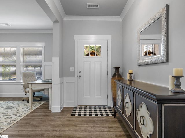 entryway featuring dark hardwood / wood-style flooring, crown molding, and a wealth of natural light