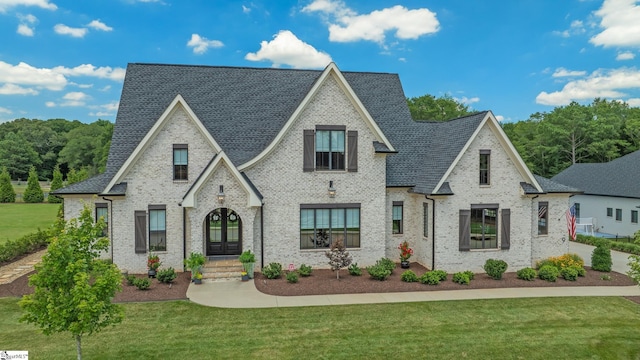 view of front of property with french doors and a front lawn