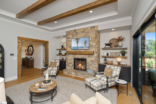 living room featuring a fireplace, light hardwood / wood-style floors, and ornamental molding