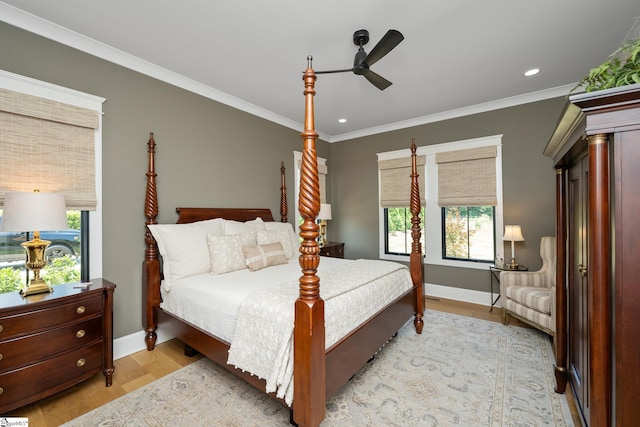 bedroom featuring light wood-type flooring, ceiling fan, and crown molding