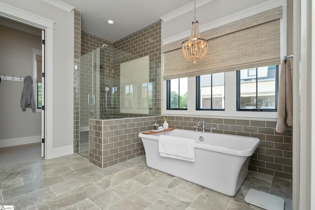 bathroom with shower with separate bathtub, an inviting chandelier, tile walls, and ornamental molding