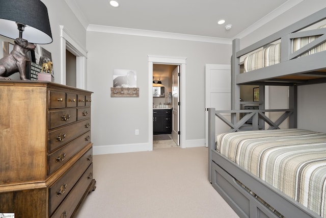 bedroom featuring light carpet, ensuite bathroom, and ornamental molding