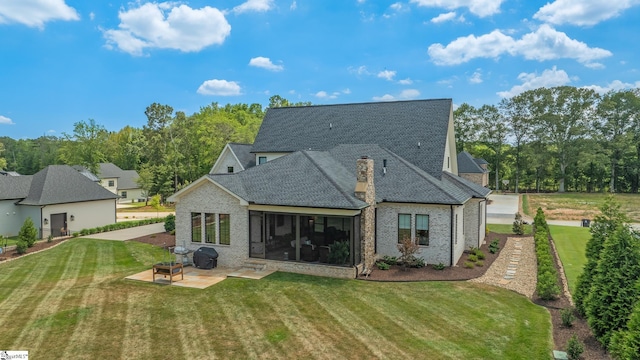 rear view of property featuring a lawn and a patio area