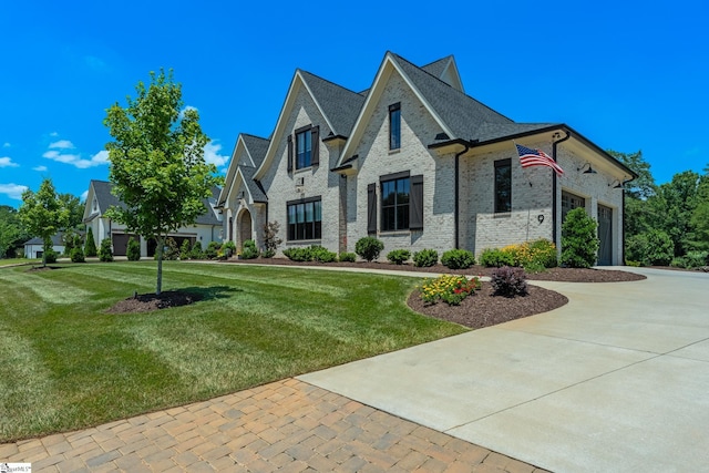 french provincial home with a front lawn