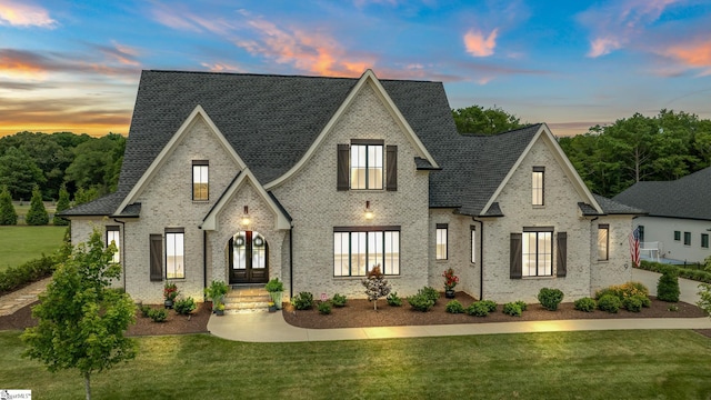 french country home with a lawn and french doors