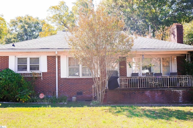 rear view of house with a lawn and covered porch