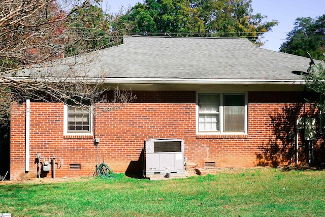 view of home's exterior with a lawn and cooling unit