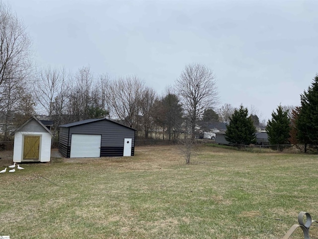 view of yard with a garage and an outdoor structure