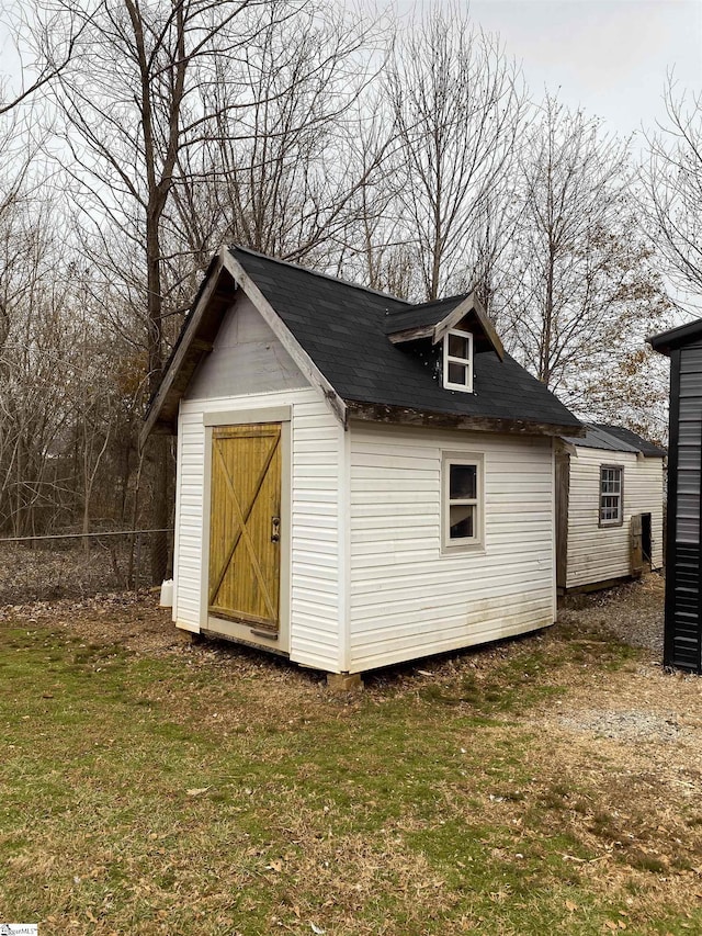 view of outbuilding featuring a yard